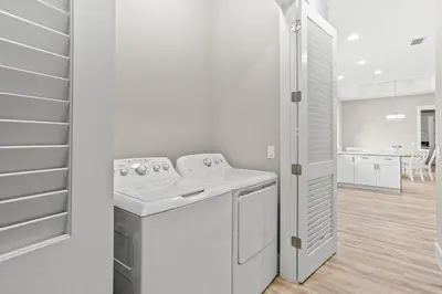 a white laundry room with a washer and dryer at 4BD3BA Beach House West end PCB in Panama City Beach