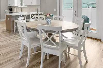 a white dining room table and chairs in a kitchen at 4BD3BA Beach House West end PCB in Panama City Beach