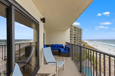 a balcony with chairs and a view of the beach at Commodore 0809 in Panama City Beach