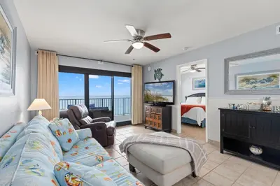 a living room with a couch and a tv at Commodore 0809 in Panama City Beach