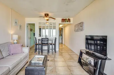 a living room with a couch and a tv at Prime Beach Access and Gulf-View Balcony! PBC Condo in Panama City Beach