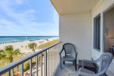 a balcony with two chairs and a view of the beach at Prime Beach Access and Gulf-View Balcony! PBC Condo in Panama City Beach