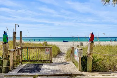 two people standing on the beach near the beach at Prime Beach Access and Gulf-View Balcony! PBC Condo in Panama City Beach