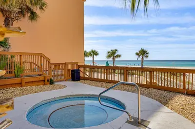 a hot tub on a patio next to the beach at Prime Beach Access and Gulf-View Balcony! PBC Condo in Panama City Beach
