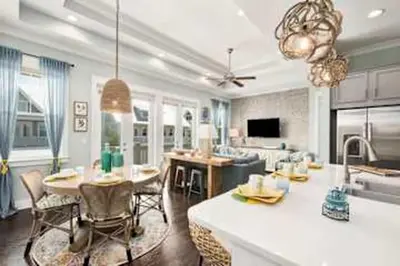 a kitchen and living room with a table and chairs at Golf Cart Included - Beach - Pool - Pet Friendly in Santa Rosa Beach