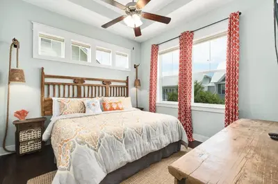 a bedroom with a bed and a ceiling fan at Golf Cart Included - Beach - Pool - Pet Friendly in Santa Rosa Beach