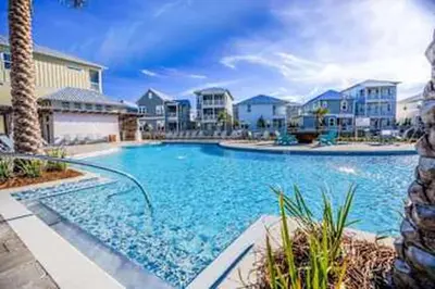 a large blue swimming pool in a resort at Golf Cart Included - Beach - Pool - Pet Friendly in Santa Rosa Beach