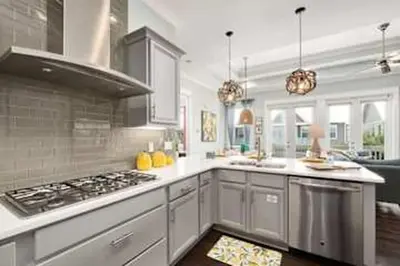 a kitchen with white cabinets and a stove top oven at Golf Cart Included - Beach - Pool - Pet Friendly in Santa Rosa Beach