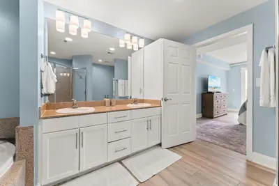 a bathroom with two sinks and a large mirror at Spacious 3BD 2BA Beach Retreat! 5 Pool Resort! by Dolce Vita Getaways PCB in Panama City Beach