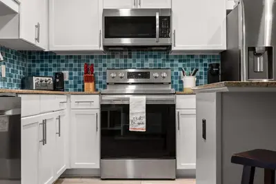 a kitchen with a stove and a microwave at Spacious 3BD 2BA Beach Retreat! 5 Pool Resort! by Dolce Vita Getaways PCB in Panama City Beach