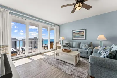 a living room with a couch and a large window at Spacious 3BD 2BA Beach Retreat! 5 Pool Resort! by Dolce Vita Getaways PCB in Panama City Beach