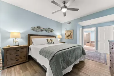 a bedroom with a bed and a ceiling fan at Spacious 3BD 2BA Beach Retreat! 5 Pool Resort! by Dolce Vita Getaways PCB in Panama City Beach