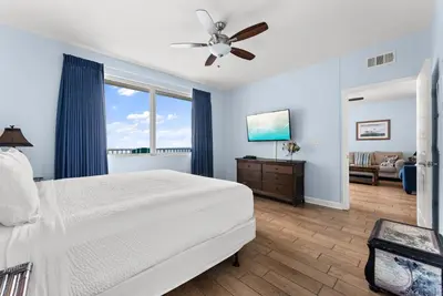 a bedroom with a bed and a ceiling fan at Shores of Panama Modern 2BR 2BA! Gulf View Resort! by Dolce Vita Getaways PCB in Panama City Beach