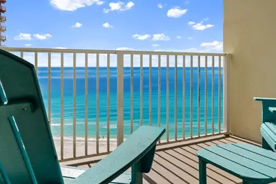 a balcony with a blue bench and the ocean at Shores of Panama Modern 2BR 2BA! Gulf View Resort! by Dolce Vita Getaways PCB in Panama City Beach