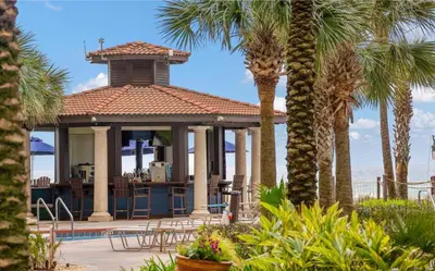 a house with a gazebo with palm trees at Shores of Panama Modern 2BR 2BA! Gulf View Resort! by Dolce Vita Getaways PCB in Panama City Beach