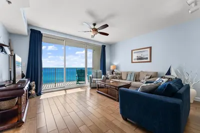 a living room with a couch and a large window at Shores of Panama Modern 2BR 2BA! Gulf View Resort! by Dolce Vita Getaways PCB in Panama City Beach