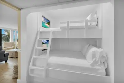 a white bunk bed in a white room at Edgewater Resort! 2BR Sleeps 8! 1st Floor Condo! by Dolce Vita Getaways PCB in Panama City Beach