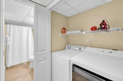 a laundry room with a washer and dryer at Edgewater Resort! 2BR Sleeps 8! 1st Floor Condo! by Dolce Vita Getaways PCB in Panama City Beach