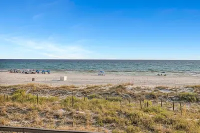 a beach with people riding horses in the water at Edgewater Resort! 2BR Sleeps 8! 1st Floor Condo! by Dolce Vita Getaways PCB in Panama City Beach