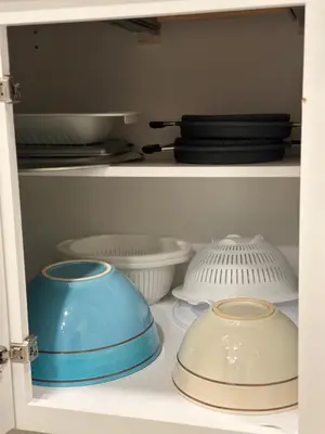 a shelf with bowls and plates and other dishes at Mermaid's Den in Panama City Beach