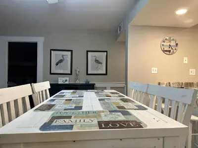 a dining room with a table with chairs at Mermaid's Den in Panama City Beach