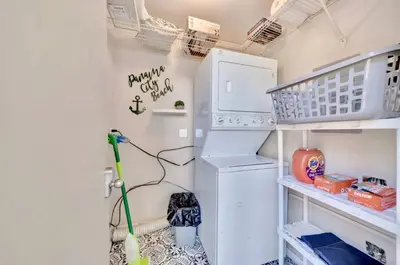 a laundry room with a washer and dryer at Coastal Getaway! Walk to Beach! Pools & Tennis! Pet Friendly! by Dolce Vita Getaways PCB in Panama City Beach