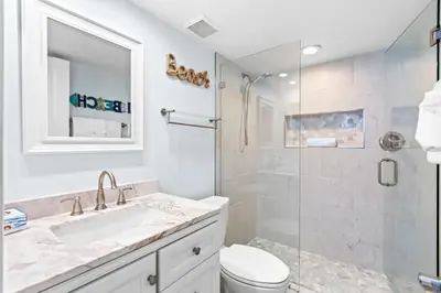 a bathroom with a toilet and a sink and a shower at One Seagrove Place 1404 in Santa Rosa Beach