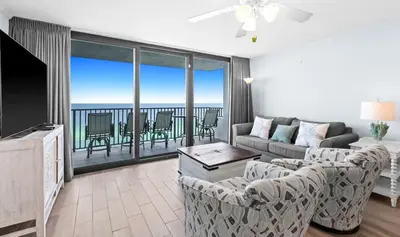 a living room with a couch and chairs and a balcony at One Seagrove Place 1404 in Santa Rosa Beach