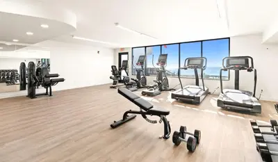 a gym with several treadmills and exercise bikes at One Seagrove Place 1404 in Santa Rosa Beach