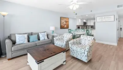 a living room with a couch and chairs and a table at One Seagrove Place 1404 in Santa Rosa Beach