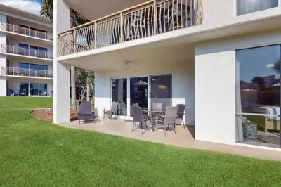 a house with a patio with a table and chairs at High Pointe Resort 115 in Seacrest