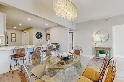 a dining room with a glass table and chairs at High Pointe Resort 115 in Seacrest