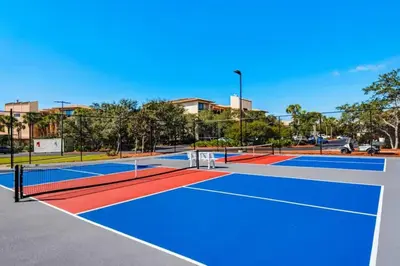a tennis court with two tennis courts at High Pointe Resort 115 in Seacrest