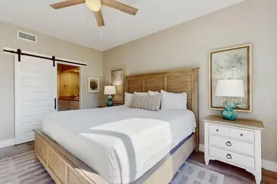 a bedroom with a large bed and a ceiling fan at High Pointe Resort 115 in Seacrest
