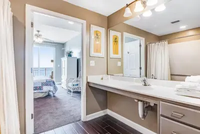a bathroom with a sink and a large mirror at Sterling Reef 405 by Emerald Coast Retreats in Panama City Beach