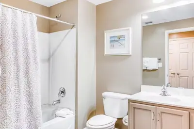 a bathroom with a toilet and a sink and a shower at Sterling Reef 405 by Emerald Coast Retreats in Panama City Beach