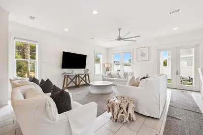 a living room with white furniture and a flat screen tv at Inlet Beach Reunion House by 30A Escapes in Inlet Beach