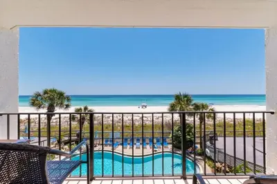 a balcony with a view of a pool and the beach at Your Paradise Awaits! in Panama City Beach