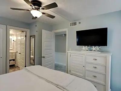 a bedroom with a bed and a flat screen tv at Your Paradise Awaits! in Panama City Beach