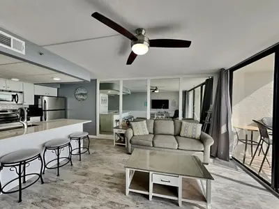 a living room with a couch and a table at Your Paradise Awaits! in Panama City Beach
