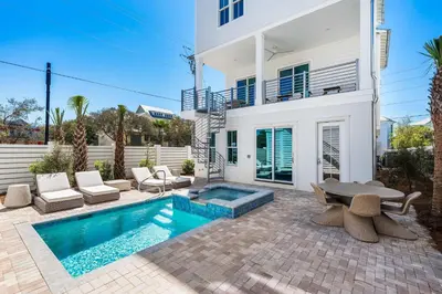 a villa with a swimming pool and a house at 30A Sunrise and Sunset in Santa Rosa Beach
