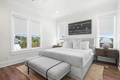 a white bedroom with a bed and windows at 30A Sunrise and Sunset in Santa Rosa Beach