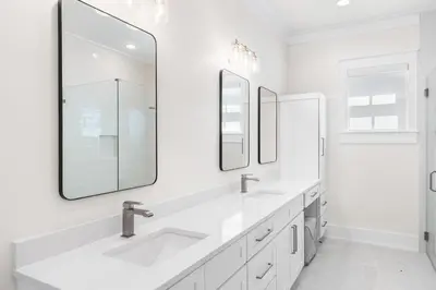 a white bathroom with two sinks and mirrors at 30A Sunrise and Sunset in Santa Rosa Beach