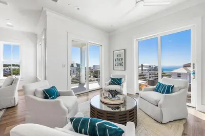 a living room with white furniture and large windows at 30A Sunrise and Sunset in Santa Rosa Beach