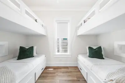 a white room with two beds and a window at 30A Sunrise and Sunset in Santa Rosa Beach