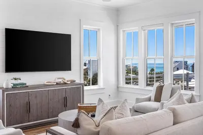 a living room with a flat screen tv on a wall at 30A Sunrise and Sunset in Santa Rosa Beach