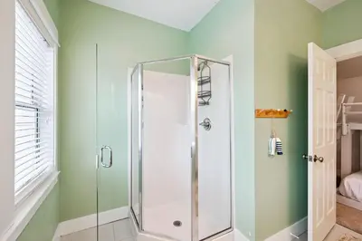 a shower in a bathroom with green walls at Downward Dog by 30A Escapes in Seacrest