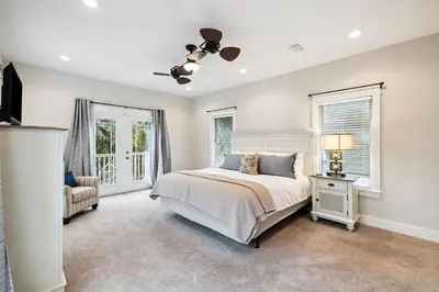 a bedroom with a bed and two windows at Downward Dog by 30A Escapes in Seacrest