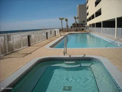 a swimming pool on a building next to the ocean at Ocean Reef Starfish in Panama City Beach