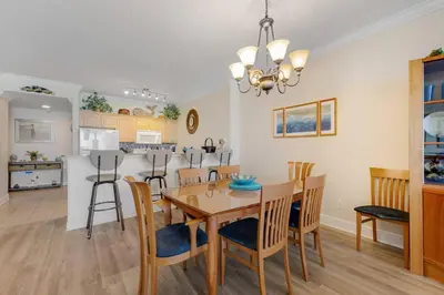 a dining room and kitchen with a table and chairs at Ocean Reef Starfish in Panama City Beach